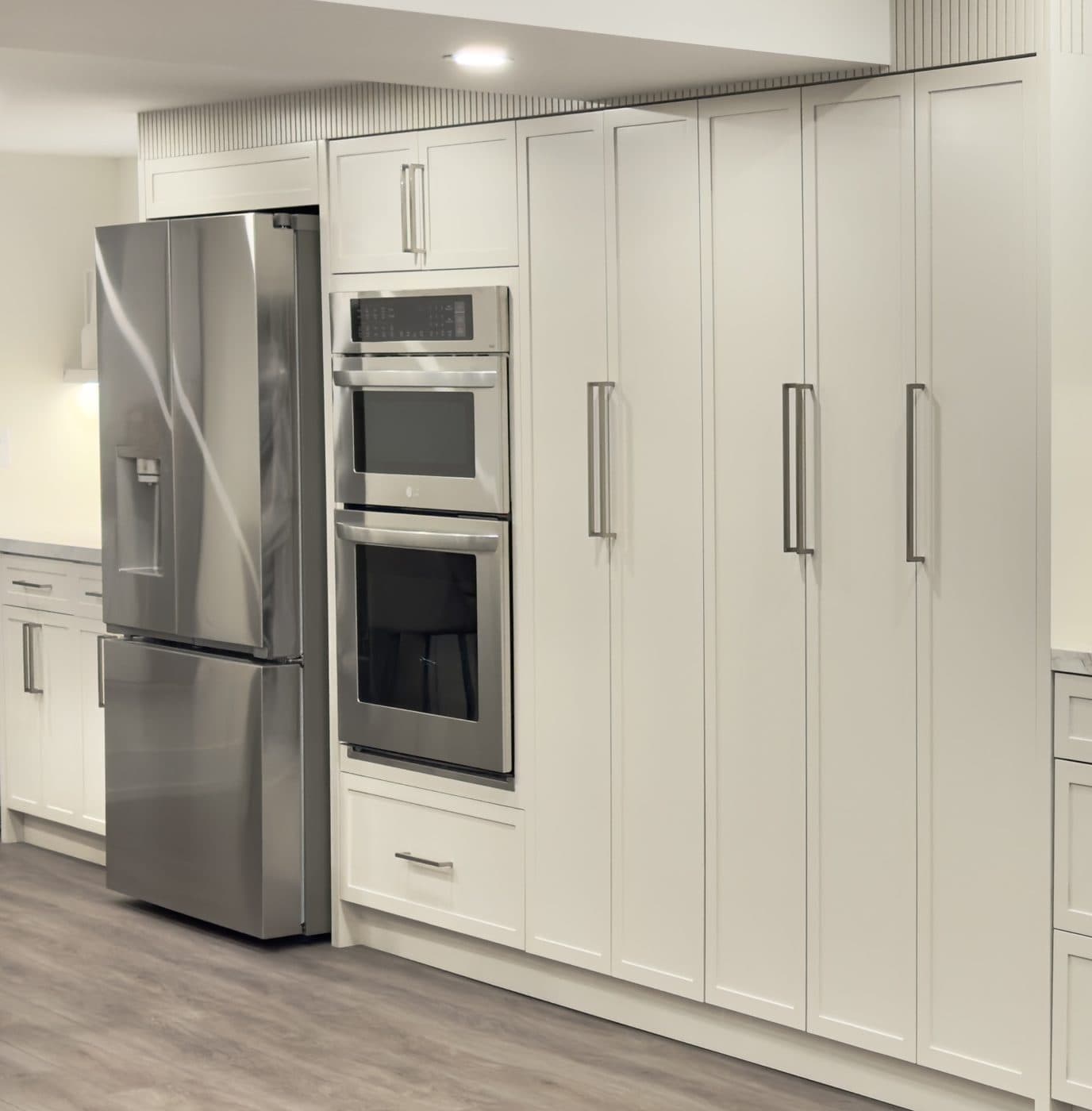Tall pantry units and integrated fridge panels, a Desire Basements project